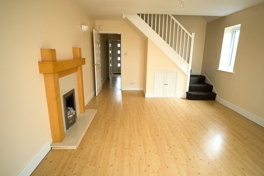 Clean living room with fire place after a house clearance